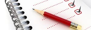 Tippet-Richardson white, red, black colored checklist with a red pencil